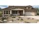 Craftsman style home with attractive stone accents and desert landscaping at 32496 N 135Th Dr, Peoria, AZ 85383