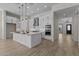 Stylish kitchen featuring an island with seating, pendant lighting, and modern appliances at 32496 N 135Th Dr, Peoria, AZ 85383