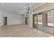 Spacious living room showcasing wood-look tile flooring and a modern chandelier at 32496 N 135Th Dr, Peoria, AZ 85383