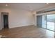 Spacious living room with neutral paint, tile floors, and sliding glass doors to the backyard at 32496 N 135Th Dr, Peoria, AZ 85383
