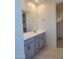 Double vanity bathroom with gray cabinets and marble tile at 33364 N 132Nd Dr, Peoria, AZ 85383