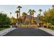 Gated community entrance with palm trees and mountain views at 3370 N 55Th Pl, Phoenix, AZ 85018