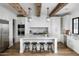 Modern kitchen featuring white cabinets, marble countertops, and an island at 3370 N 55Th Pl, Phoenix, AZ 85018