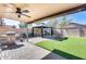 Wonderful backyard oasis with a covered patio, fire pit, and putting green at 3610 N 106Th Ave, Avondale, AZ 85392