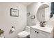 Clean bathroom with white vanity, round mirror, and decorative accents at 3610 N 106Th Ave, Avondale, AZ 85392