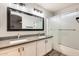 Modern bathroom with double sinks, a large mirror, and a walk-in shower at 3610 N 106Th Ave, Avondale, AZ 85392