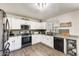 Bright kitchen with white cabinets, stainless steel appliances, and a view of the backyard at 3610 N 106Th Ave, Avondale, AZ 85392