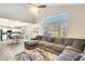 Spacious living room with L-shaped sectional sofa and view of kitchen at 3610 N 106Th Ave, Avondale, AZ 85392