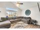 Spacious living room featuring a large sectional sofa and wood-look tile floors at 3610 N 106Th Ave, Avondale, AZ 85392