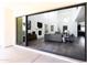 View of living room from backyard through sliding glass doors at 3928 E Crittenden Ln, Phoenix, AZ 85018