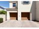 Two-car garage with wood-style doors and paved driveway at 3928 E Crittenden Ln, Phoenix, AZ 85018