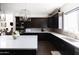 Modern kitchen with white countertops and dark cabinets at 3928 E Crittenden Ln, Phoenix, AZ 85018