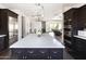 Modern kitchen with island, white countertops, and dark cabinets at 3928 E Crittenden Ln, Phoenix, AZ 85018