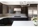 Modern kitchen with white countertops and dark cabinets at 3928 E Crittenden Ln, Phoenix, AZ 85018