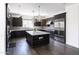 Modern kitchen with island, white countertops, and dark cabinets at 3928 E Crittenden Ln, Phoenix, AZ 85018