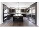 Spacious kitchen featuring an island, dark cabinetry, and stainless steel appliances at 3928 E Crittenden Ln, Phoenix, AZ 85018