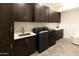 Laundry room with dark cabinets, washer, and dryer at 3928 E Crittenden Ln, Phoenix, AZ 85018