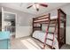 Well-lit bedroom with a bunk bed and access to upper level at 3984 E Los Altos Dr, Gilbert, AZ 85297