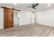 Spacious bedroom with wood-look tile floors and barn door closet at 4314 E Forest Pleasant Pl, Cave Creek, AZ 85331