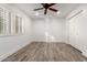 Well-lit bedroom with wood-look floors, plantation shutters and ceiling fan at 4314 E Forest Pleasant Pl, Cave Creek, AZ 85331