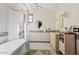 Charming bathroom with subway tile, a freestanding tub, and a vintage vanity at 4417 N Camino Allenada --, Phoenix, AZ 85018