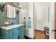 Stylish powder room with unique tile, a teal vanity, and marble countertop at 4417 N Camino Allenada --, Phoenix, AZ 85018