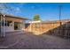 Backyard with covered patio, wooden fence, and grassy area at 4622 W Desert Crest Dr, Glendale, AZ 85301