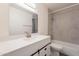 Modern bathroom with white vanity, gray tile, and a bathtub at 4622 W Desert Crest Dr, Glendale, AZ 85301