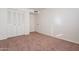 Simple bedroom with carpeting, double doors, and light-colored walls at 4622 W Desert Crest Dr, Glendale, AZ 85301