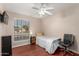 Bright bedroom with wood floors, large window, and ceiling fan at 4639 W Becker Ln, Glendale, AZ 85304