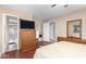 Spacious bedroom with dresser, TV, and en-suite bathroom at 4639 W Becker Ln, Glendale, AZ 85304