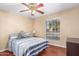 Cozy bedroom with striped bedding and wood floors at 4639 W Becker Ln, Glendale, AZ 85304