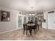 Dining area with tile floor, table and chairs, and view into kitchen at 4639 W Becker Ln, Glendale, AZ 85304