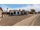 Front view of a single story home showcasing its white exterior and rock landscaping at 4639 W Becker Ln, Glendale, AZ 85304