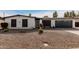 Single story home with white exterior, gray garage door, and well-maintained landscaping at 4639 W Becker Ln, Glendale, AZ 85304