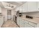 Updated kitchen featuring white cabinets and tile flooring at 4639 W Becker Ln, Glendale, AZ 85304