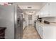 Modern kitchen with stainless steel appliances and white cabinets at 4639 W Becker Ln, Glendale, AZ 85304