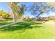 Landscaped grounds with lush lawn, mature trees, and walking path at 5018 E Siesta Dr # 3, Phoenix, AZ 85044