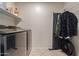 Laundry room with washer, dryer, shelving, and hanging rod at 5018 E Siesta Dr # 3, Phoenix, AZ 85044