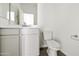 Simple bathroom with single sink, toilet and grey cabinets at 5018 W Walatowa St, Laveen, AZ 85339