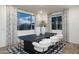 Elegant dining room with black table, white chairs, and patterned rug at 5018 W Walatowa St, Laveen, AZ 85339