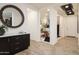 Elegant entryway with dark cabinetry and large mirror at 5018 W Walatowa St, Laveen, AZ 85339