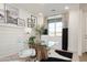 Bright home office with glass-top desk and white chairs at 5018 W Walatowa St, Laveen, AZ 85339