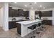 Modern kitchen with dark cabinetry, island, and stainless steel appliances at 5018 W Walatowa St, Laveen, AZ 85339