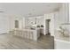 Modern kitchen with white shaker cabinets, quartz countertops, and an island at 5018 W Walatowa St, Laveen, AZ 85339