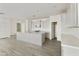 Modern kitchen with white shaker cabinets, quartz countertops, and an island at 5018 W Walatowa St, Laveen, AZ 85339