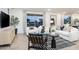 Bright living room featuring white sofas, a glass coffee table, and large windows at 5018 W Walatowa St, Laveen, AZ 85339