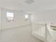 Spacious loft area with carpeted floor, neutral walls, and a white railing at 5018 W Walatowa St, Laveen, AZ 85339