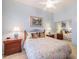 Bedroom with floral bedding and mirrored closet at 5287 W Quail Ave, Glendale, AZ 85308