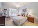 Charming bedroom with floral bedding, window seating, and wooden furniture at 5287 W Quail Ave, Glendale, AZ 85308